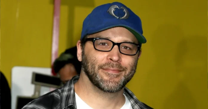 Brian Redban Net Worth: Brian Redban in a blue cap and plaid shirt at an event.