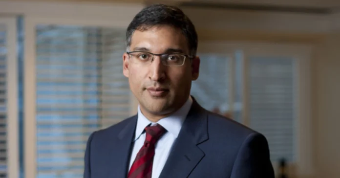 Neal Katyal Net Worth: Portrait of America's highest-earning minority litigator in professional attire with red tie against office backdrop