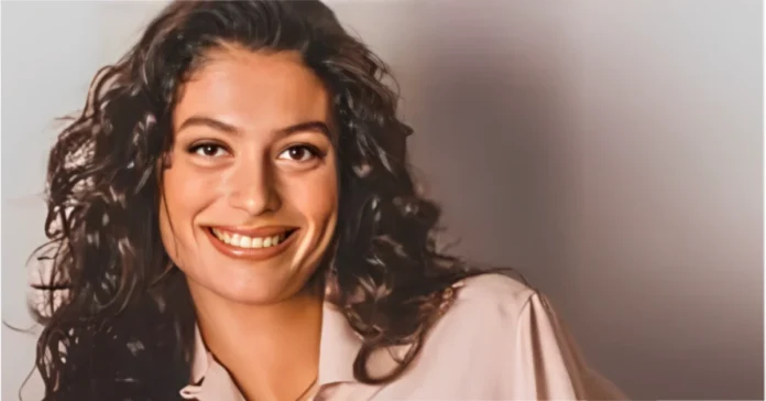 lynsi hughes smiling portrait in a light pink shirt, 2025 photo