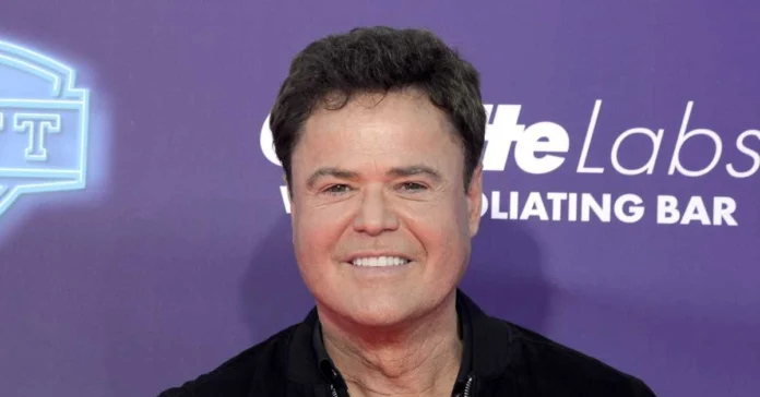 Donny Osmond attends a celebrity event, featured in an article discussing Donny Osmond Net Worth, career milestones, and financial success.
