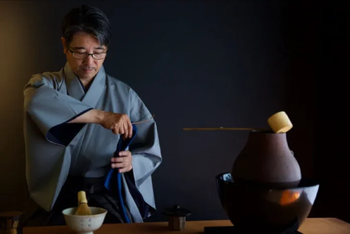 A tranquil Japanese Tea Ceremony unfolds, revealing meticulous preparation and serene participants engaged in the time-honored ritual.