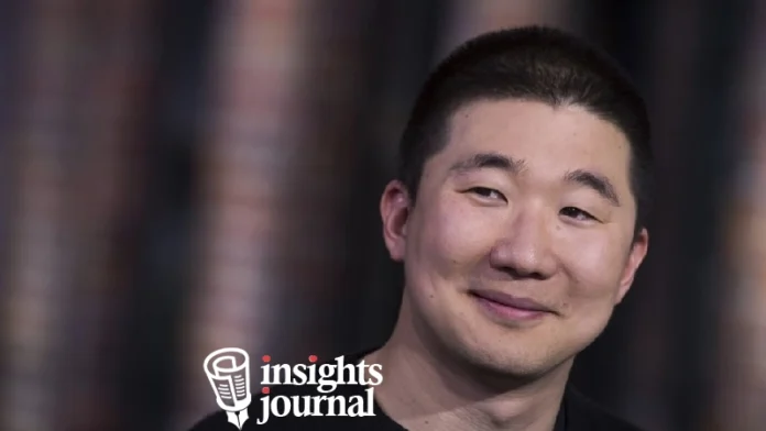 Howie Liu net worth - Airtable founder and tech entrepreneur standing in modern office with company logo in background