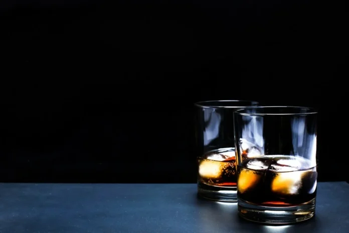 Two glasses of The Irishman 17-Year-Old Single Malt whiskey with ice cubes, showcasing its rich amber color and premium quality.