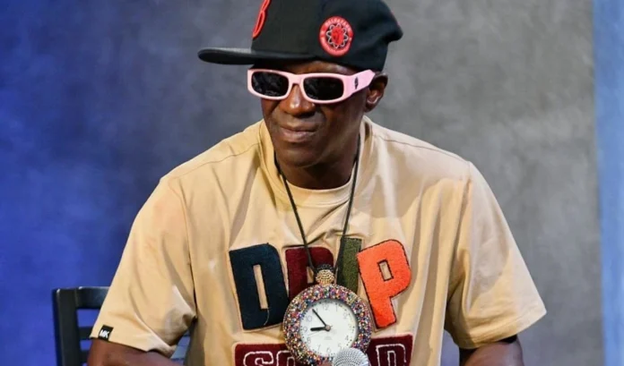 Flavor Flav Net Worth Flavor Flav performing live in his iconic clock necklace—an energetic visual that reflects the legacy and Flavor Flav net worth story.
