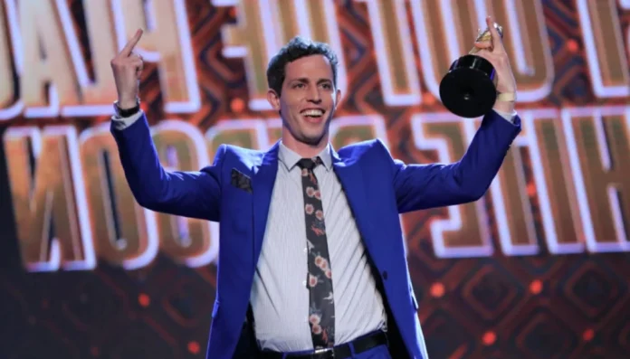 tony hinchcliffe net worth Tony Hinchcliffe on stage performing stand-up comedy, representing his career success and the rise of Tony Hinchcliffe net worth over the years.
