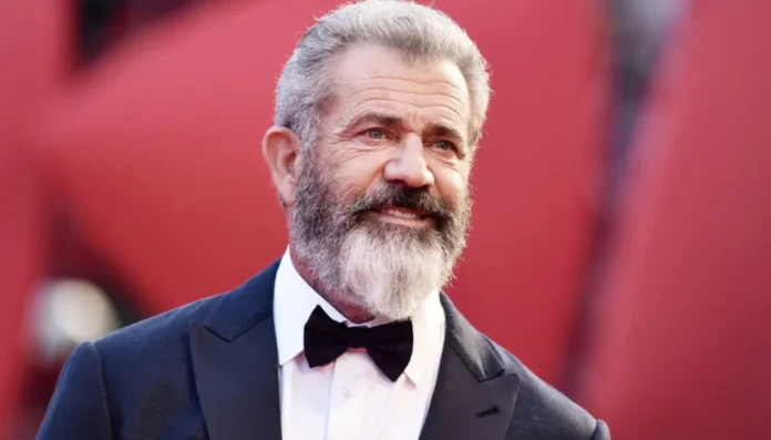 Mel Gibson smiling at a film premiere, symbolizing success and wealth—an ideal image to represent mel gibson net worth in the entertainment industry.